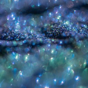 Abstract glitter lights colorful bokeh background in blue green and purple color